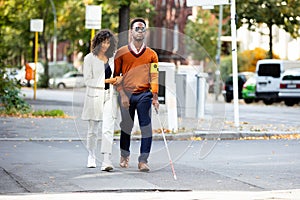 Woman Assisting Blind Man On Street