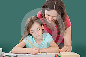 Woman Assisting Daughter In Studying