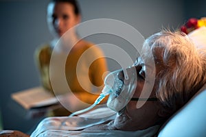 Woman assisting a senior patient at the hospital