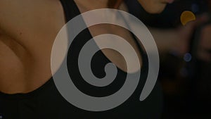 A woman athlete, trains on the chest and front delts shoulder in the gym Close-up