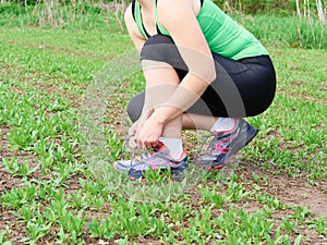 woman athlete tying running shoes.