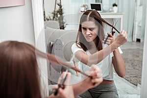 Woman attempting to cut her hair herself