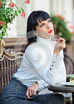 Woman attractive brunette eat gourmet cake cafe terrace background. Gastronomical enjoyment. Gourmet concept. Girl relax