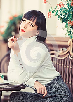Woman attractive brunette eat gourmet cake cafe terrace background. Gastronomical enjoyment. Gourmet concept. Girl relax