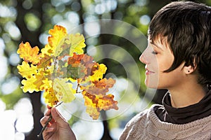 Woman with autumn leaves