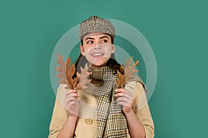 Woman with autumn leaves on isolated background with copy space.