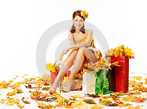 Woman autumn shopping in dress of maple leaves over white