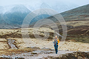 Woman with baby carrier traveling hiking family healthy lifestyle