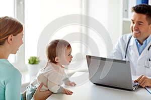 Woman with baby and doctor with laptop at clinic