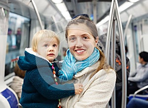 Woman with baby in subway train
