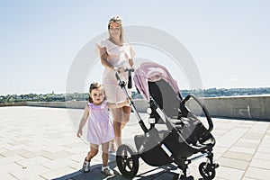Woman with babystroller and child run outside