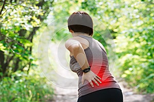 Woman with back pain, kidney inflammation, injury during workout photo