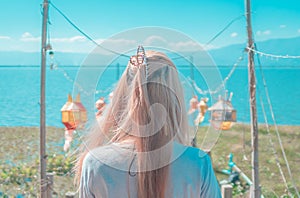 Woman back traveling in Lake with Asian decorated pier in Phayao Distric of Thailand