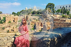 Woman on the background of archaeological excavations of Carthage