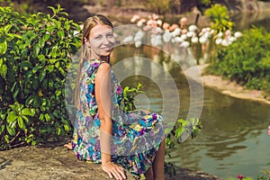 Woman on a background of flamingos on a pond