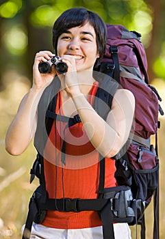 Woman with backpack and binoculars