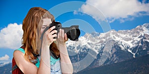 Woman with backpack and camera over alps mountains