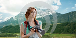 Woman with backpack and camera over mountains