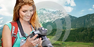 Woman with backpack and camera over mountains