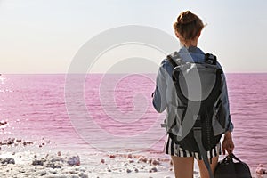 Woman with backpack on coast