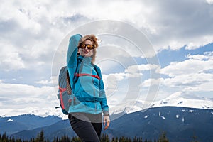 Woman with backpack enjoying the mountain view