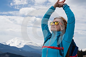 Woman with backpack enjoying the mountain view