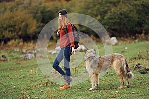 woman with backpack on her back nature tourism walking dog