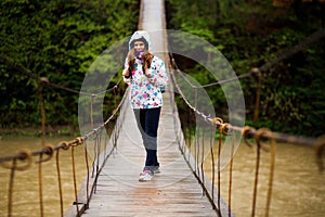 Woman with backpack hiking Lifestyle adventure concept forest and cross river in forest