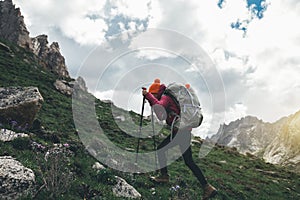 Woman with backpack hiking in mountains