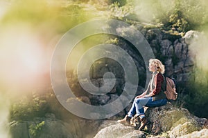 Woman with backpack hiking in the mountains