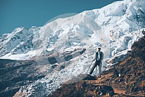 Woman with backpack on the mountain peak