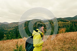 woman with a backpack in mountains