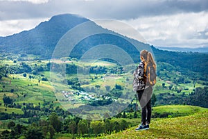 Woman with backpack on mountaintop at Khao Ta-Khian Ngo Viewpoint