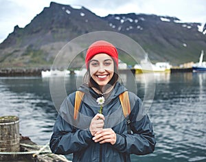 Woman with backpack on pier with flower