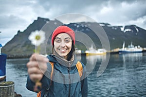 Woman with backpack on pier with flower