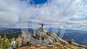 Ladinger Spitz - Woman with backpack standing on massive rock formation at Steinerne Hochzeit, Saualpe, Lavanttal Alps, Austria photo