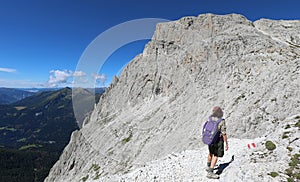 woman with backpack during a summer hiking in the Italian Dolomi