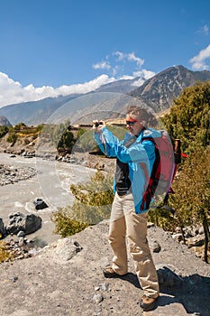 Woman with backpack takes photos