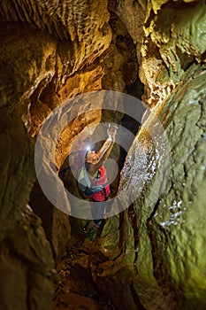 Woman with backpack taking photos in a cave