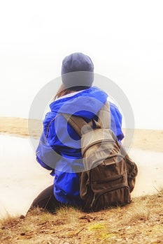 Woman with backpack traveling hiking. Lifestyle adventure concept forest and lake on background active vacations into the wild. Tr