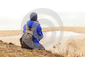 Woman with backpack traveling hiking. Lifestyle adventure concept forest and lake on background active vacations into the wild. Tr