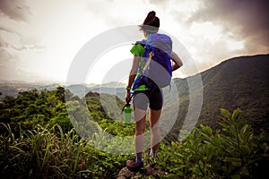 Woman backpacker on beautiful mountain top