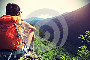 Woman backpacker enjoy the view at mountain peak