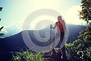 Woman backpacker enjoy the view on mountain peak