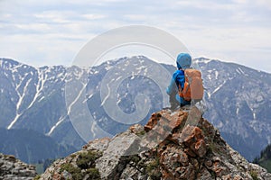 Woman backpacker enjoy the view on mountain peak cliff