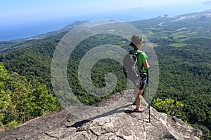 Woman backpacker enjoy the view on mountain peak