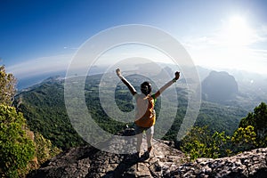 Woman with backpacker enjoy the view on mountain top