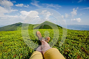 Woman backpacker enjoy the view on summer mountains