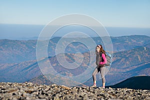 Woman backpacker enjoying the open view on the mountains