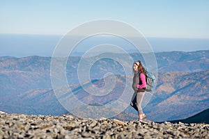 Woman backpacker enjoying the open view on the mountains